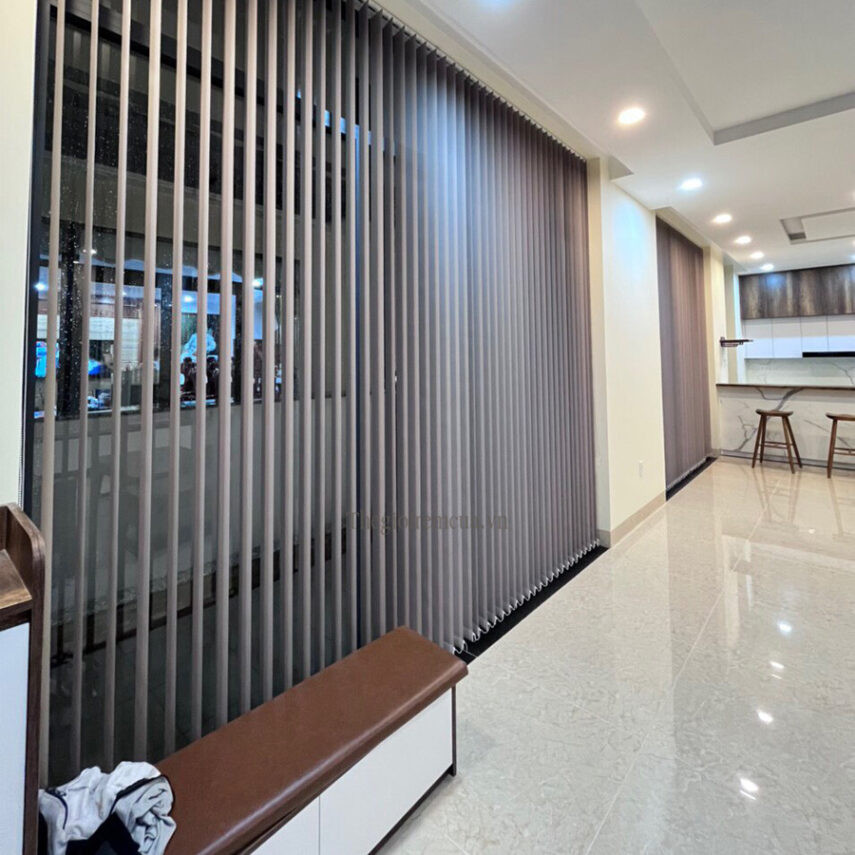 Kỹ thuật viên đang lắp đặt rèm cửa nhựa lá dọc cho một ô cửa lớn, đảm bảo khả năng ngăn lạnh tối ưu.